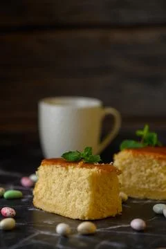 Vertical rustic tabletop photograph of sponge cake slices, colorful candy-c.. Stock Photos