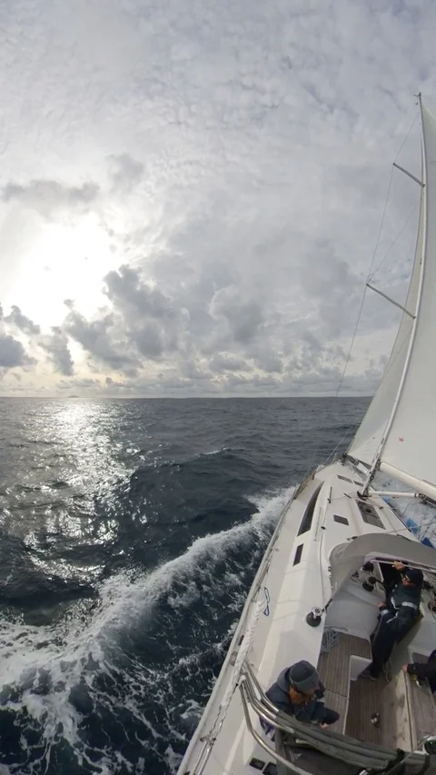 Vertical, Sailboat run over the winter sea,cloudy with sun, 360 effect, rear Stock Footage 120745012