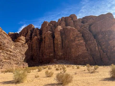 Vertical sandstone cliffs in Wadi Rum desert, Jordan Stock Photos