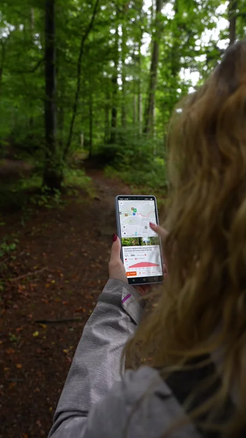 Vertical scene of woman using navigation app in nature Stock Footage 328065333