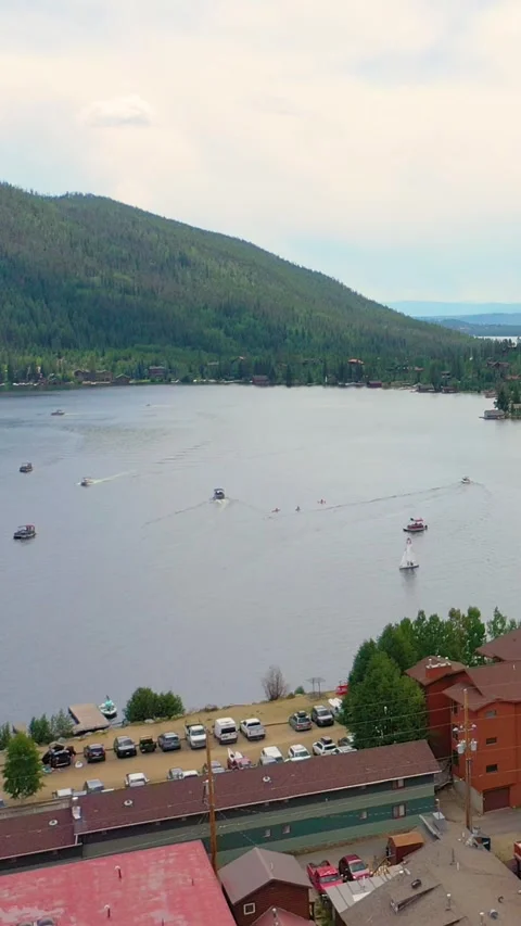 Vertical scenic drone view of Big Bear Lake with waterfront resorts, boats on Stock-Footage 334104351