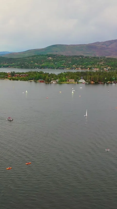 Vertical scenic drone view of Lake George with small boats, waterfront homes Stock Footage 334109105