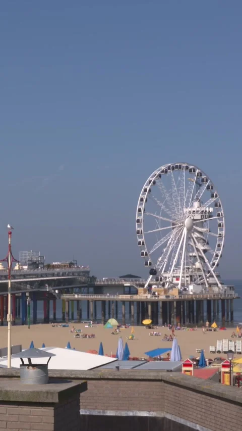 Vertical - SCHEVENINGEN Ferris wheel on The Pier turning Stock Footage 309614479