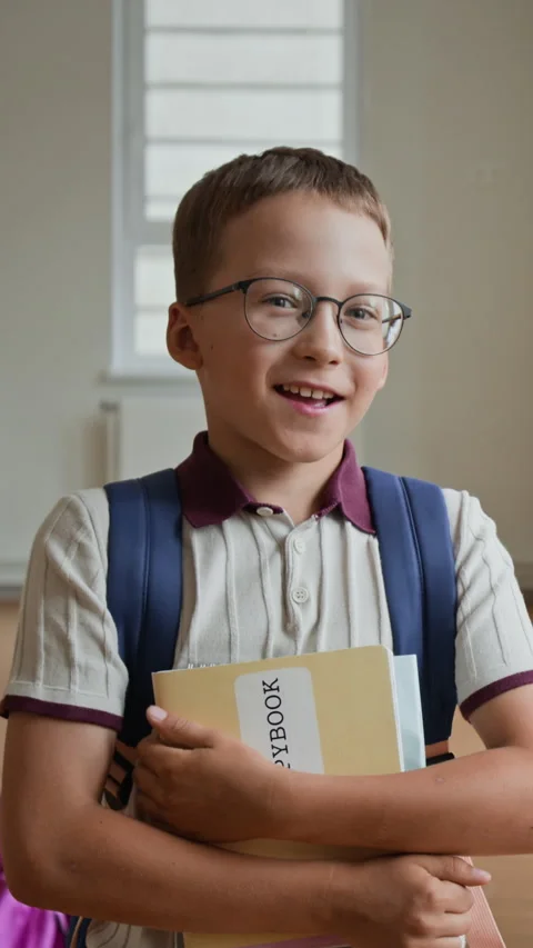 Vertical of Schoolboy Holding Notebooks Talking at School Stock Footage 345822379