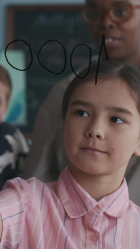 Vertical of Schoolgirl Solving Addition Problem During Math Lesson in Class Stock Footage 312591068