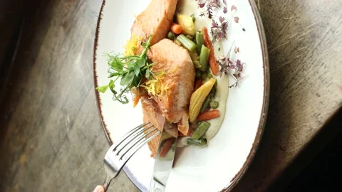 Vertical Screen 4K Close up Hands cut Roasted Salmon with fork and knife. Stock Footage 153023464