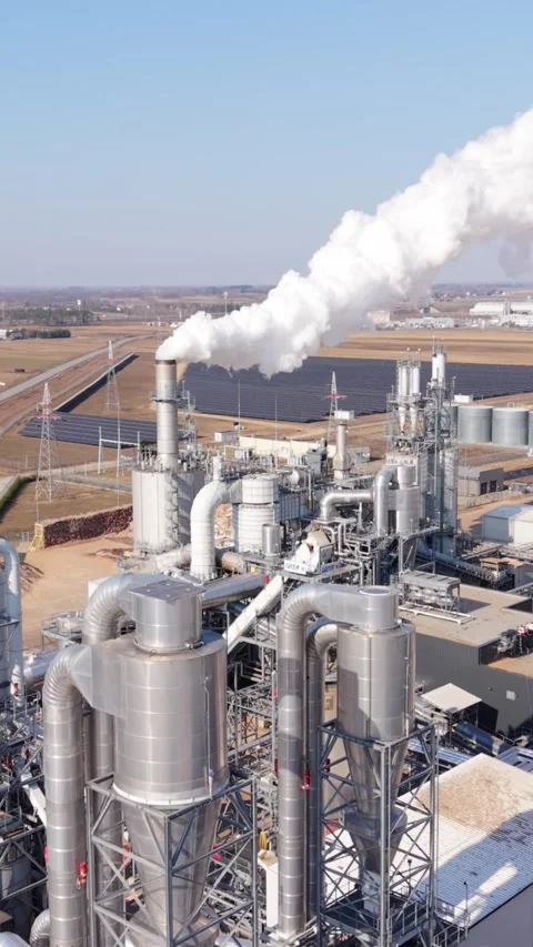 Vertical screen Aerial Chemical Processing Complex Releasing White Plume Stock Footage 336742990