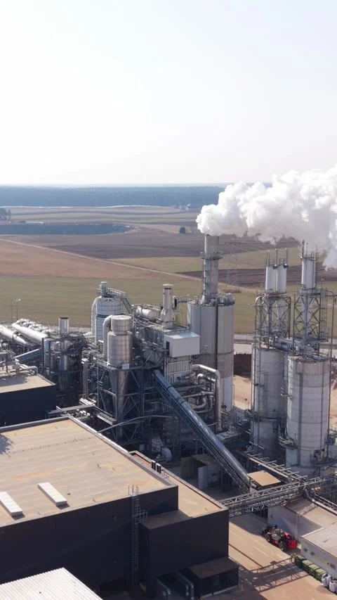 Vertical screen Aerial Drone Inspection Over Industrial Complex Emitting Steam Stock Footage 336738465