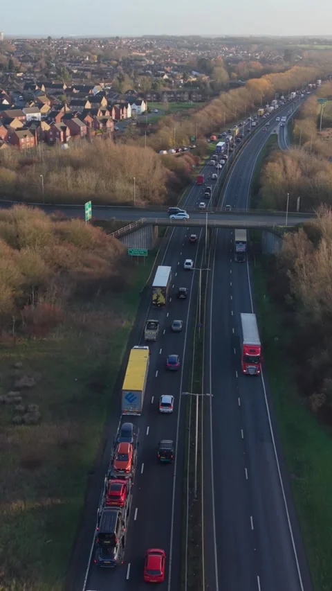 Vertical screen Aerial Highway Freight Tailback Scene With Long Queue Of Trucks Stock Footage 333778789