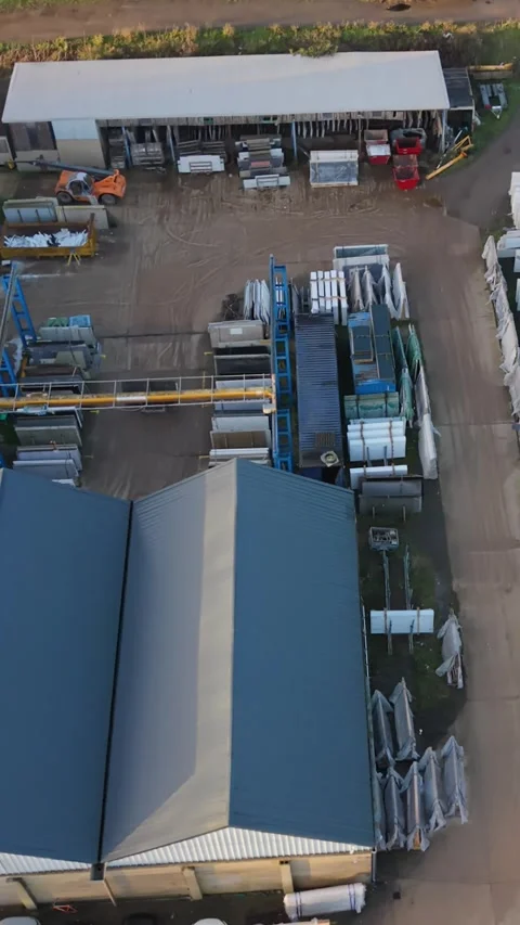 Vertical screen Aerial Industrial Yard Stacked Materials Vehicles Daytime Vídeo Stock 333197836