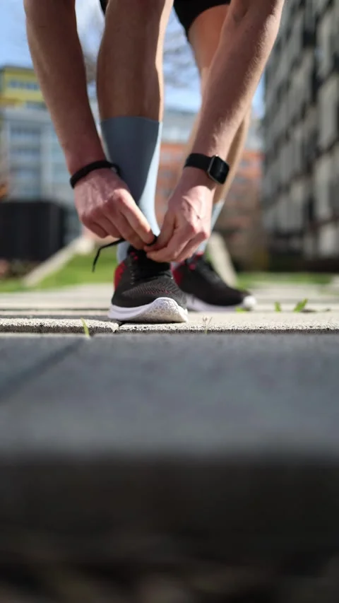 Vertical screen. After stepping outside, a young man decided to get into fitness Stock Footage 305999067