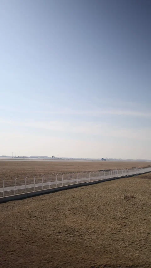 Vertical screen: An Airbus A321 takes off, leaving the runway behind. The airpor Stock Footage 303907675