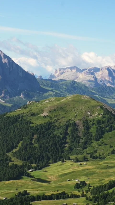 Vertical screen alpine slope and valley with distant Dolomites mountain peaks in Stockbeeldmateriaal 318355670