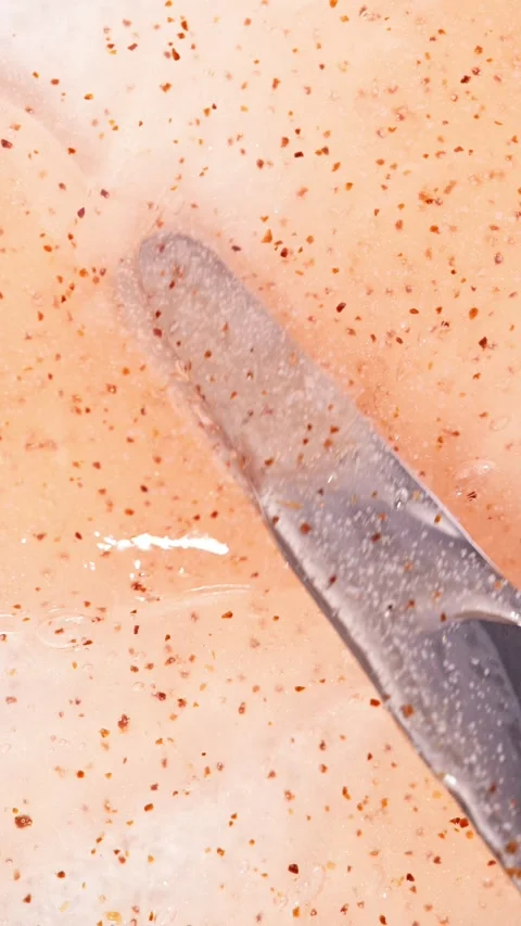 Vertical Screen: Apricot body scrub texture with natural granules. Stock Footage 310736085