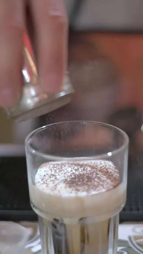 Vertical screen Asian Chef Dusting Cocoa Over Foam. Fine Powder Falls From Stock Footage 331121780