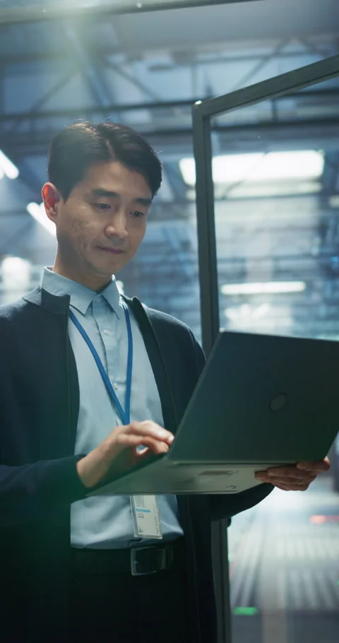 Vertical Screen Asian Data Center Engineer Using Laptop Computer Stock Footage 320001347