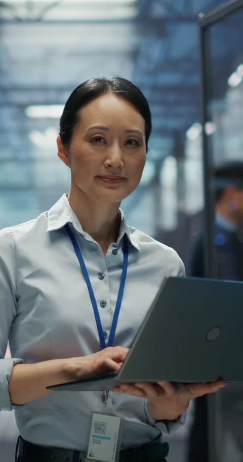 Vertical Screen Asian Female Data Center Engineer Using Laptop Comp Stock Footage 320001318