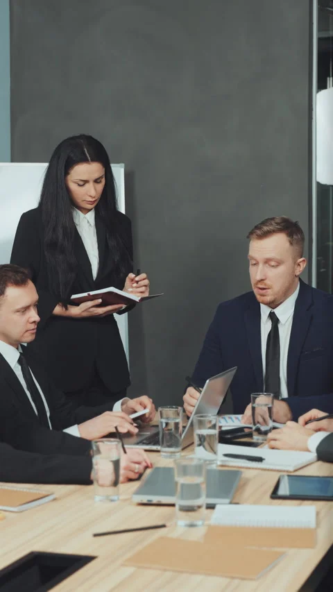 Vertical screen: Assistant taking detailed meeting notes Stock Footage 294094336