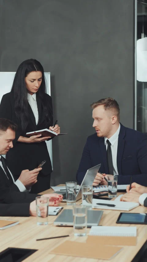 Vertical screen: Assistant taking notes during meeting Stock Footage 280679089