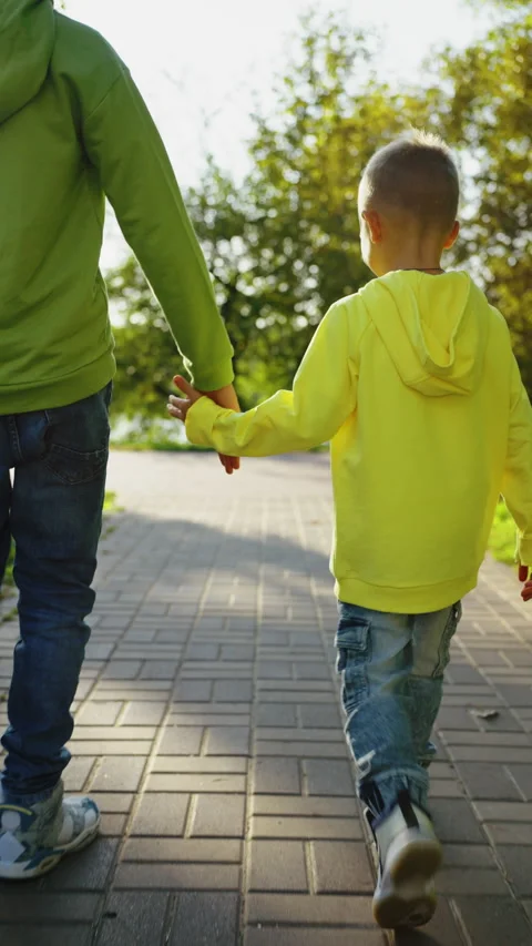 Vertical Screen: Back view two boys walking in park Stock Footage 267351880