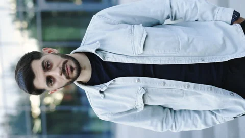 Vertical screen of bearded handsome young caucasian man standing look at camera Stock Footage 200223945