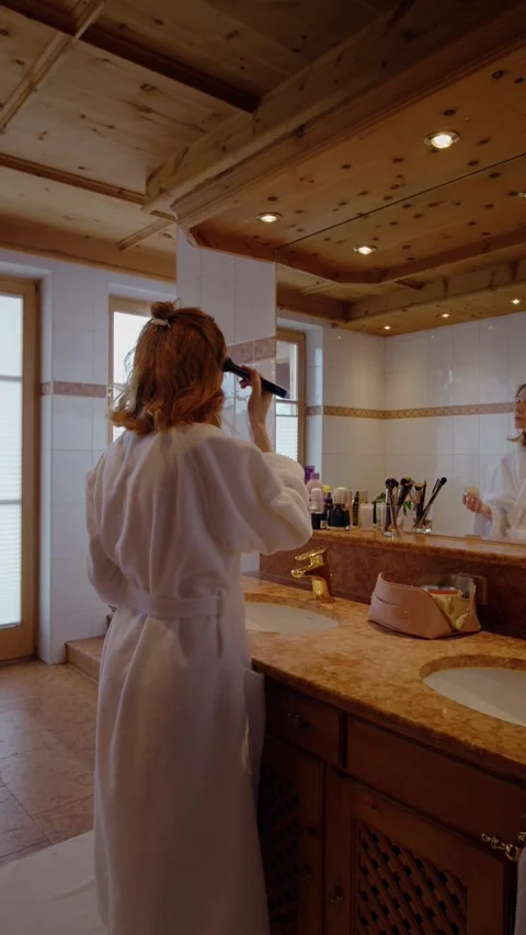 Vertical Screen Beauty routine done by middle aged woman in the bathroom mirror. Stock Footage 303442302