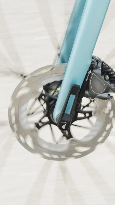 Vertical Screen: The bicycle wheel is spinning. Glare of the sun through the Stock Footage 274593460