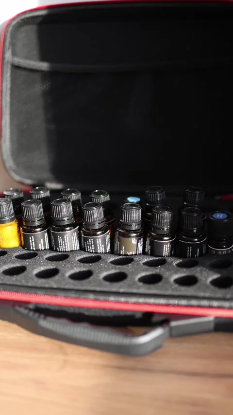 Vertical screen: A black and red case with neatly arranged essential oil bottles Video stock 297107396