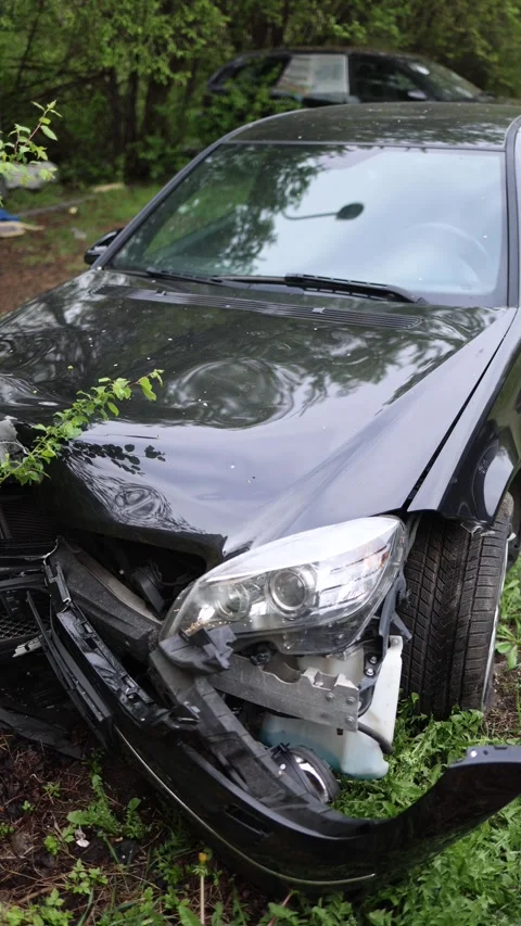 Vertical screen black car crash closeup front end heavily damaged surrounded by  Stock Footage 307142500