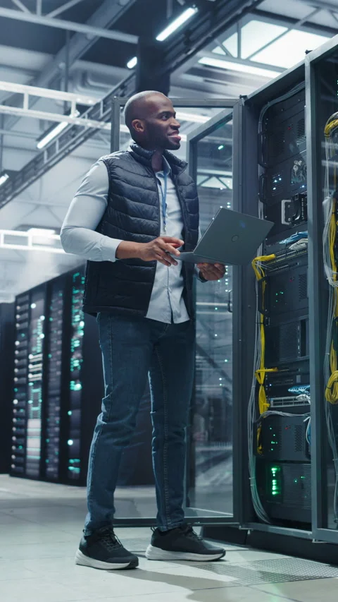 Vertical Screen Black Data Center Engineer Using Laptop Computer Video stock 320867699