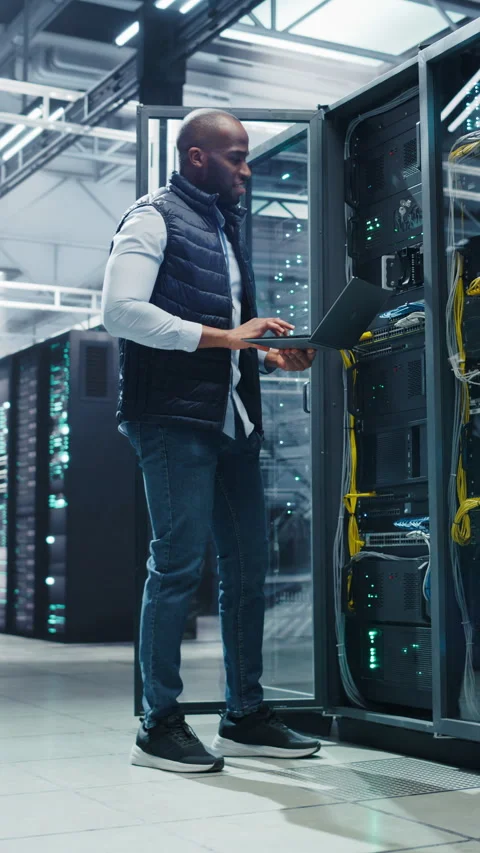 Vertical Screen Black Data Center Engineer Using Laptop Computer Stock Footage 320867716