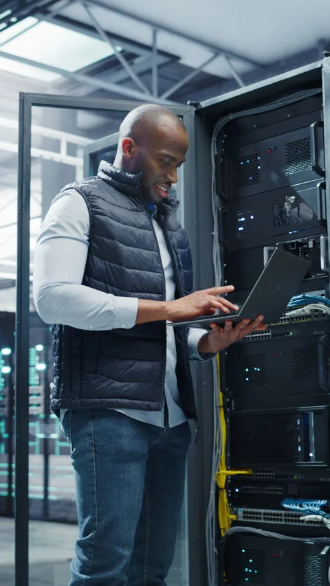 Vertical Screen Black Data Center Engineer Using Laptop Computer Video stock 320867719