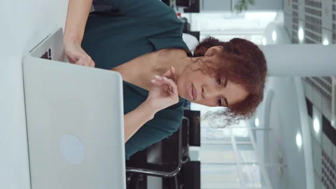 Vertical Screen: Black woman using laptop in coworking space Stock Footage 167566168