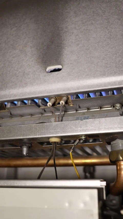 Vertical screen boiler burner ignites with blue flames starting seasonal home he Stock Footage 344054824