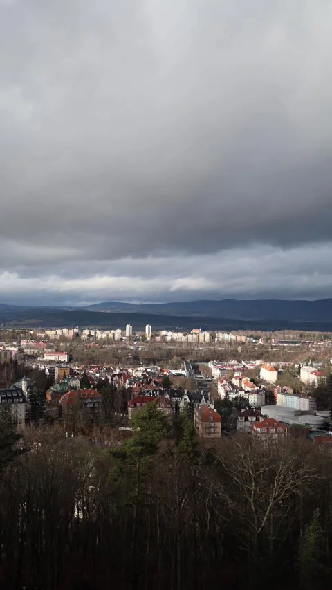 Vertical screen: A breathtaking view of a town below, with a mix of modern build Stock Footage 300539641