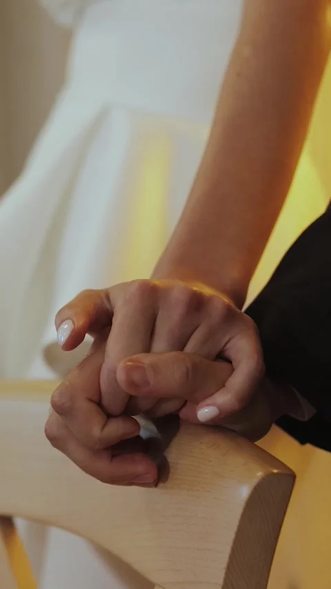 Vertical screen: A bride and groom share a heartfelt moment, hands intertwined Stock Footage 308396186