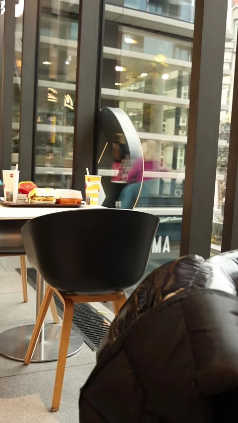 Vertical screen: A bright and modern cafe interior with a table set for a fast-f Stock Footage 299367941