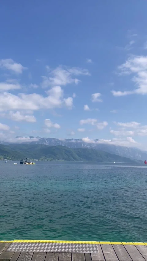 Vertical screen bright lake near high mountains sunny clear day Stock Footage 296532716
