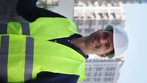 Vertical Screen: Building inspector showing thumb up against multistory houses Stock Footage 168741519