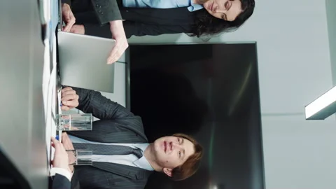 Vertical screen: Business partners shaking hands after signing contract Stock Footage 252801601