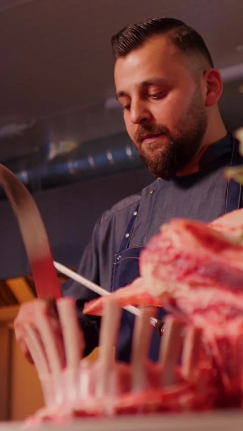 Vertical Screen Butcher sharpens his knife. Stock Footage 299954201
