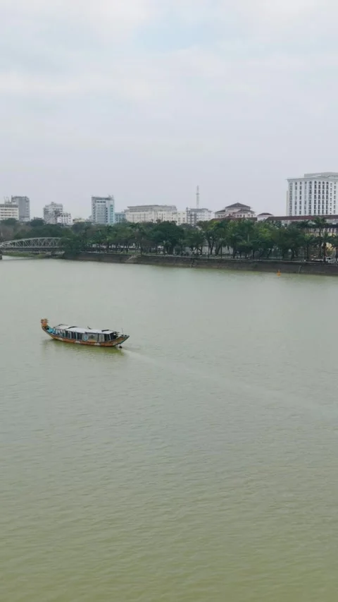 Vertical screen Calm Cruise Along City Waters. Silent Expedition Through Urban Stock Footage 339999051