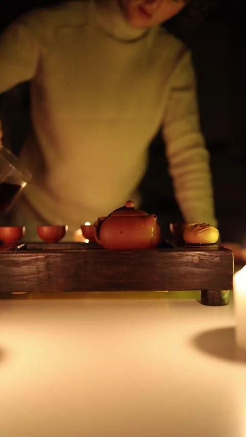 Vertical screen: A calming moment during a tea ceremony, where a person carefull Stock Footage 299379939