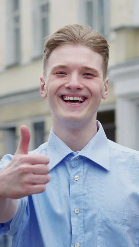 Vertical Screen: Caucasian man smiling confident doing ok sign with thumbs up Stock Footage 293102512