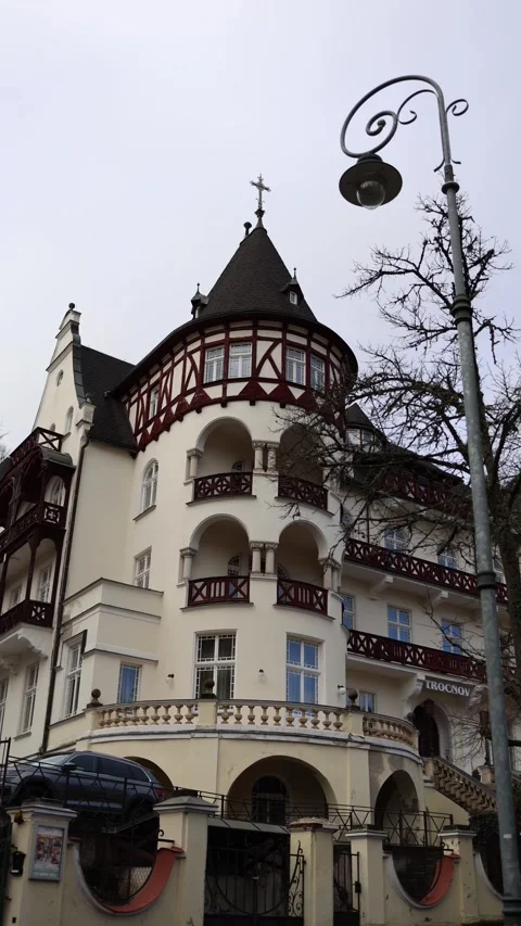Vertical screen: A charming building with a rounded tower and intricate woodwork Stock Footage 300539931