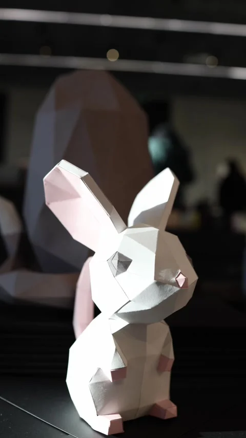 Vertical screen: A charming geometric rabbit sculpture, crafted with angular pre Vídeos de archivo 304459499