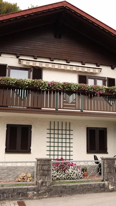 Vertical screen charming house facade with wooden balcony decorated by colorful  Stock Footage 318217415