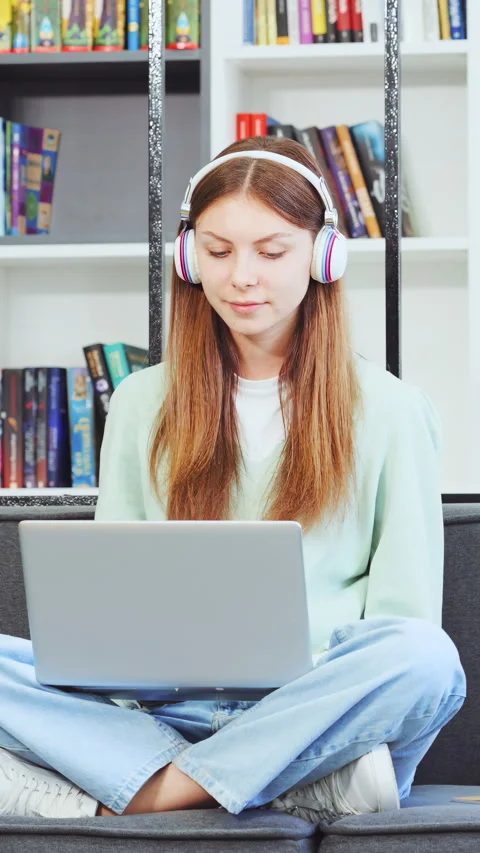 Vertical Screen: Cheerful female working on notebook in library Stock Footage 270293583