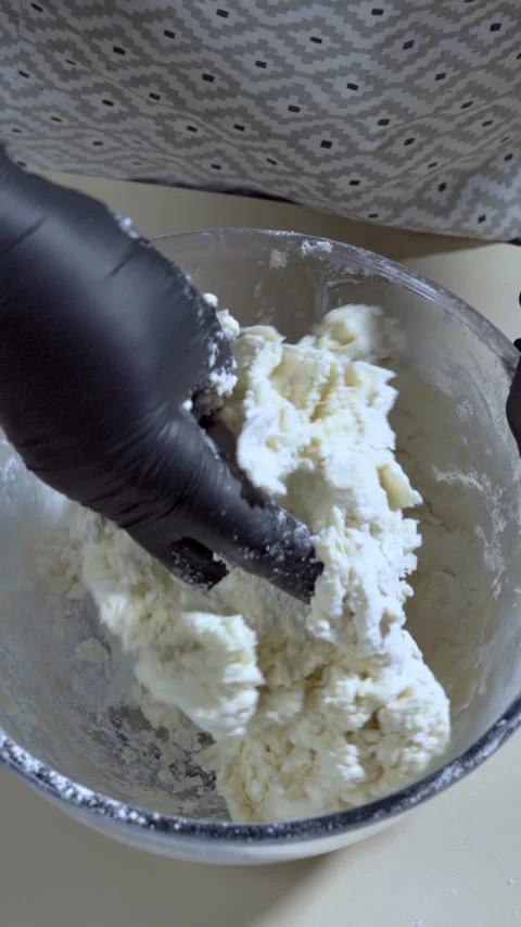 Vertical screen. Chef stirring cookie dough in a glass bowl. Slow motion. Stock Footage 301230586