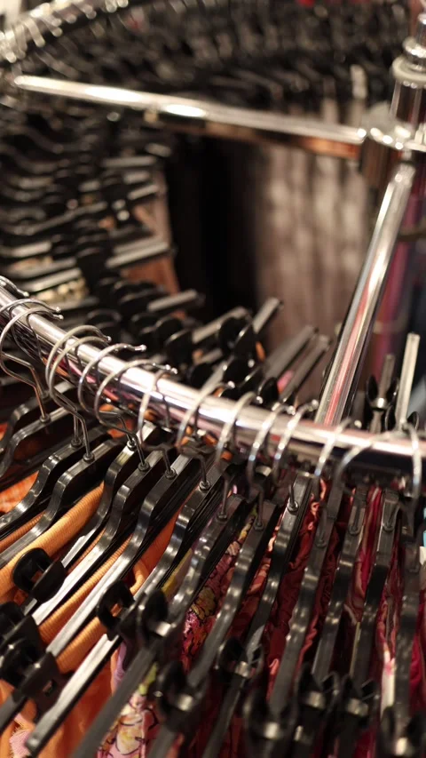 Vertical screen circular rack packed with hangers displaying a wide Stock Footage 330014840